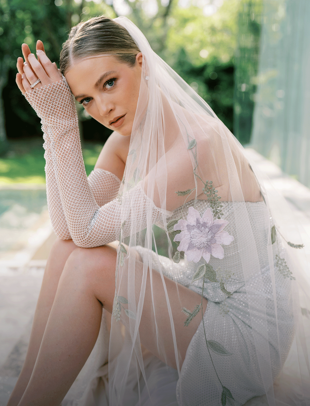 model is wearing a wedding dress and a toni federici veil