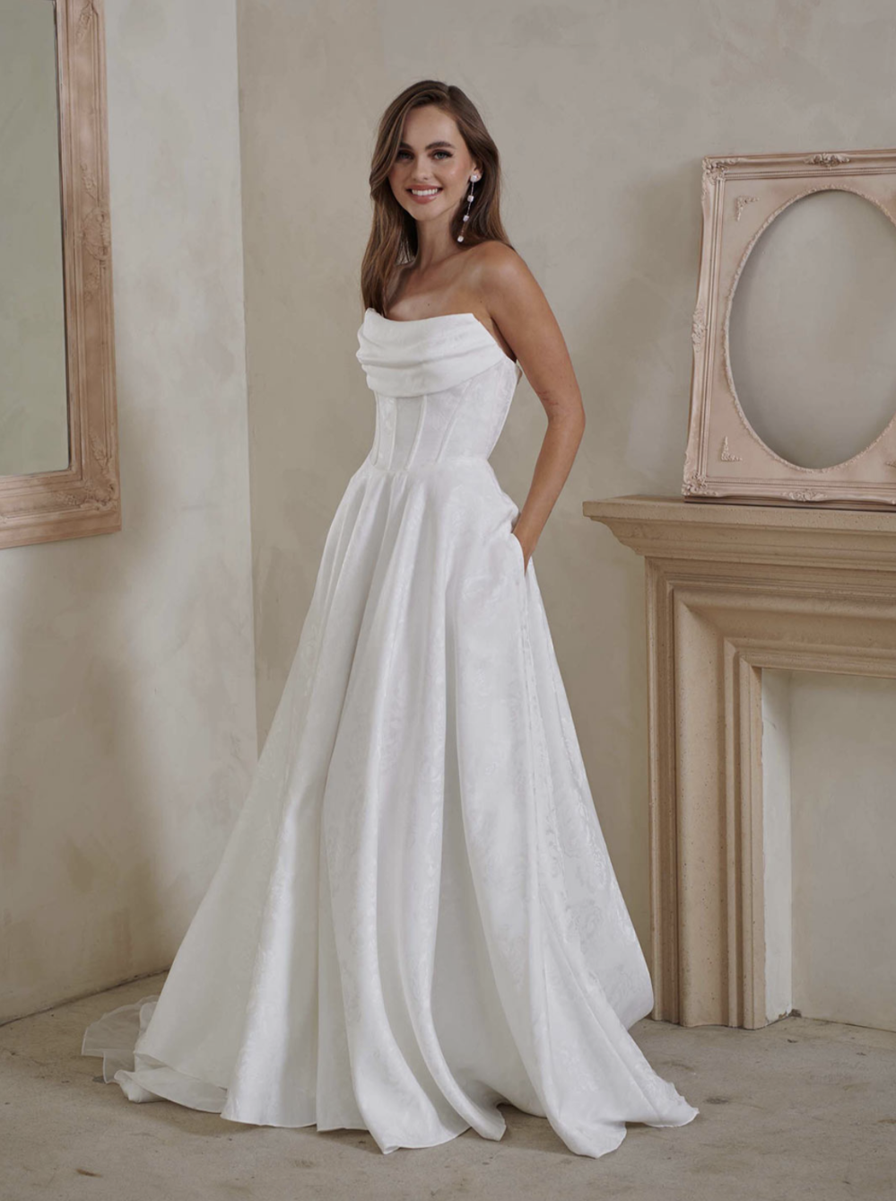 model is wearing a strapless a-line bridal gown