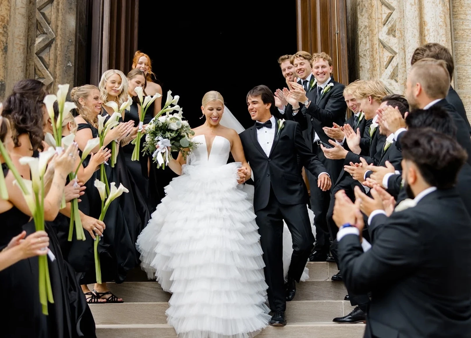 Сouple wearing a white gown and a black suit