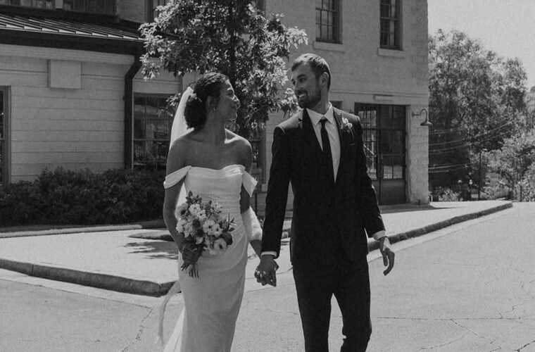 Сouple wearing a white gown and a black suit
