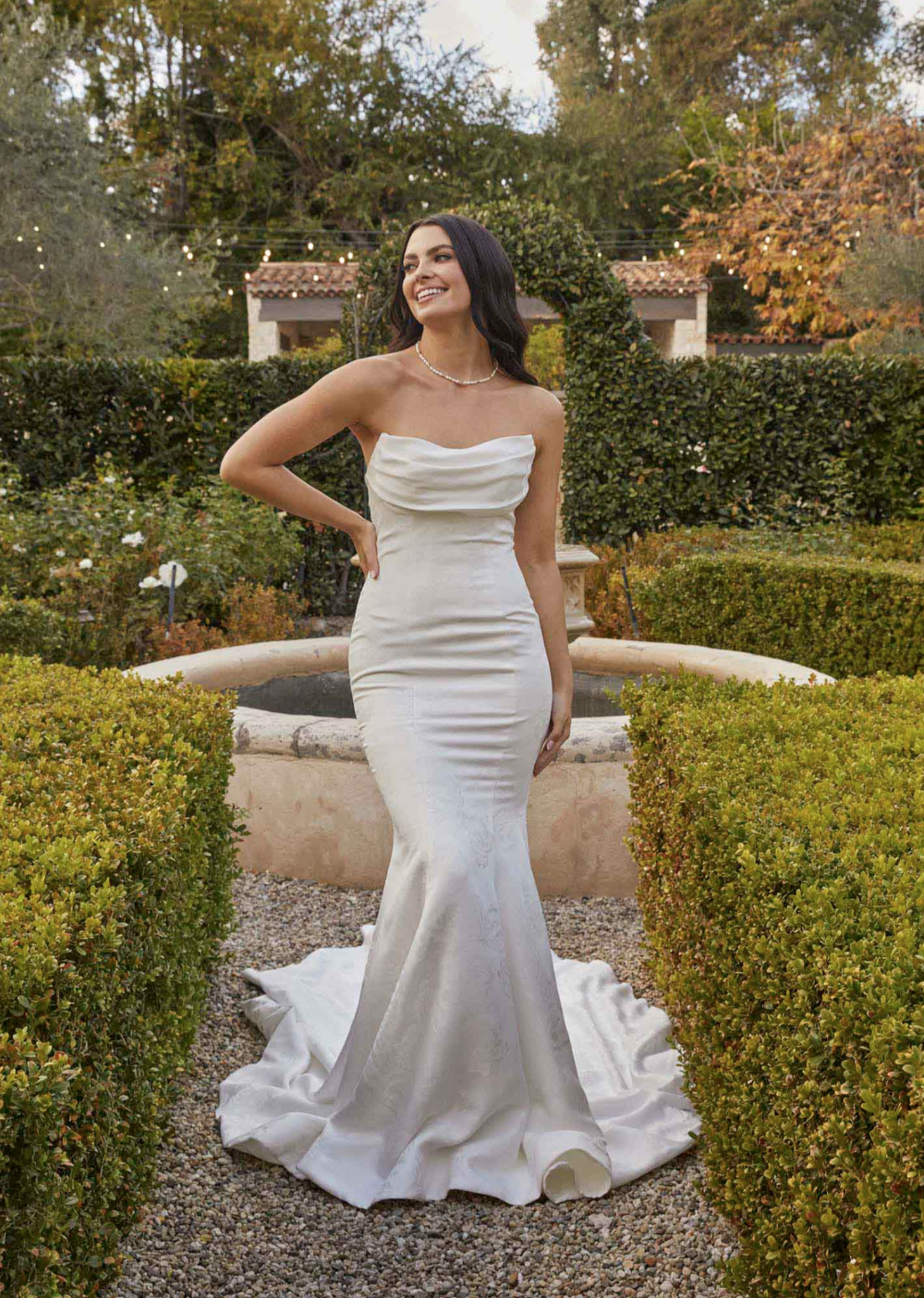 model is wearing a minimalist bridal gown by madi lane