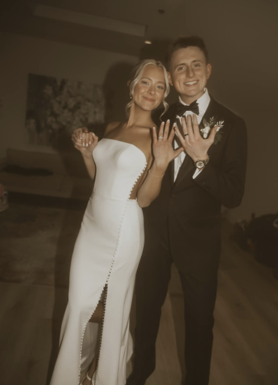 Сouple wearing a white gown and a black suit